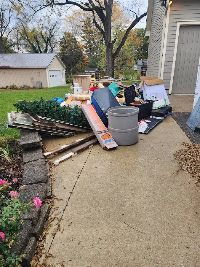Dumpster being loaded with debris for Roofing Dumpster Rental in Jasper